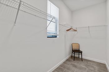 a room with a closet and a chair and a window at Odyssey, Fort Myers, FL, 33905
